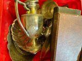 a silver vase sitting in a red box on a table