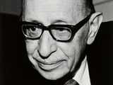 photographie en noir et blanc d'un homme portant des lunettes et un costume