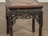 une vieille table en bois recouverte d'un plateau en carrelage, posée sur un parquet