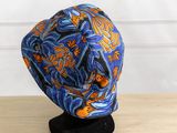 a blue hat with orange and blue designs on it