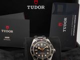 a tudor watch in a black box with a box of cards