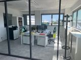 a glass wall in an office with a view of the city