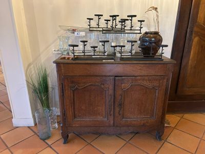 a wooden cabinet with candles on top of it