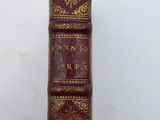 an old book sitting on top of a white table
