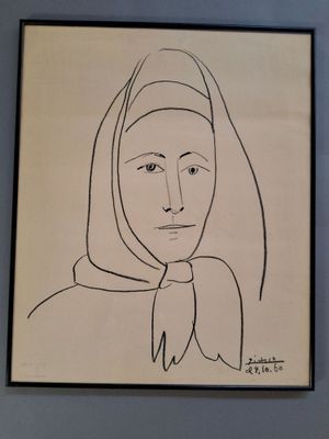 drawing of a woman with a scarf on her head in a black frame