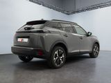 the rear view of a grey suv parked in a garage