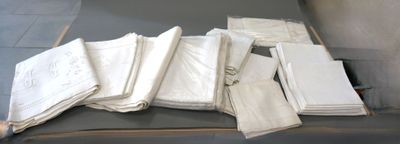 a pile of white napkins sitting on top of a table