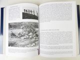 a book open on a table with a picture of a group of people