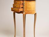 a small wooden table with two drawers on it