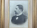 an old photo of a man in a suit and bow tie
