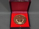 an image of a gold medal in a red box on a table