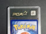a close up of a pokemon card in a plastic case