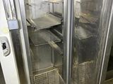 a glass door in a commercial kitchen with a lot of food