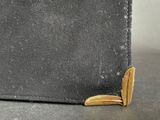 a close up of a book with a gold edge on a table