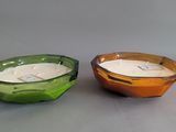 two bowls with a candle inside of them on a table
