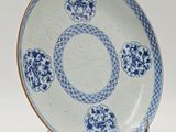 blue and white plate with a circular design on it
