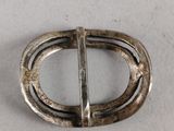 a close up of a metal buckle on a white surface