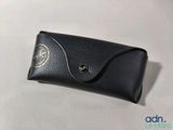 an image of a black leather case with a gold emblem on it