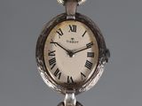 a silver clock with roman numerals on it