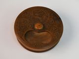 an old brass plate with a decorative design on it