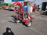 a small red machine that is parked in a parking lot
