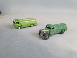 two toy trucks that are sitting next to each other