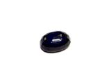 a close up of a blue sapphire stone on a white surface