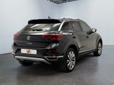 the rear end of a black volkswagen suv parked in a garage