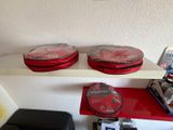 two red cases on a white shelf next to a black chair