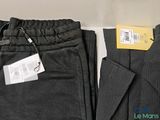 two men ' s pants with tags on them sitting next to each other