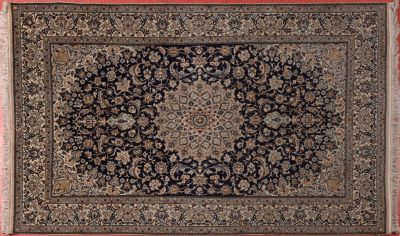 a black and beige rug with a medallion design on it