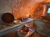 pots and pans on a counter in a kitchen with a window