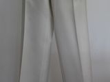 a mannequin wearing a white suit on a mannequin stand