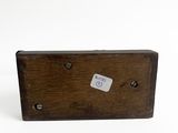 an old wooden box with a sticker on it sitting on a white surface