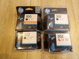 three hp 302 ink cartridges are sitting on top of each other