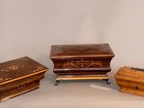 three pieces of furniture sitting on top of a table next to each other
