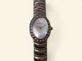 an image of a woman ' s wrist watch with a mother of pearl dial