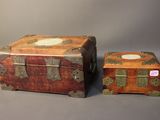 two trunks sitting next to each other on a table