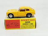 a yellow toy car sitting on top of a box