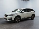 un SUV blanc garé dans une pièce blanche au sol noir