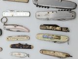 many different types of pocket knives on the table