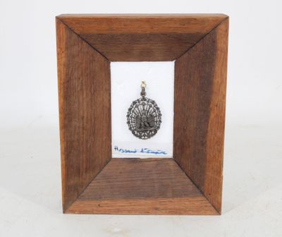 an image of a picture of a wooden frame with a silver medal in it