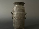 a silver vase that is sitting on a table