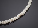 a cultured pearl necklace with a clasp on a black background