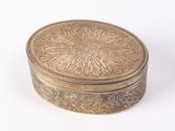 a gold box with a flower design on it