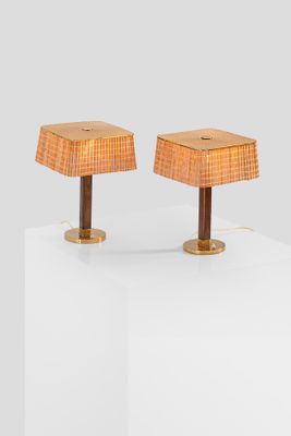 pair of table lamps with rattan lampshads on wooden bases