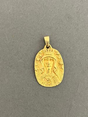 a gold coin with a face of jesus on it