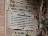 a sign on the wall of a building that says switch adjustment