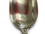 a spoon that is sitting on a white surface