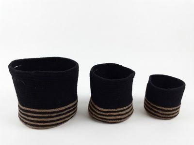 three black and brown striped baskets sitting on top of a white surface